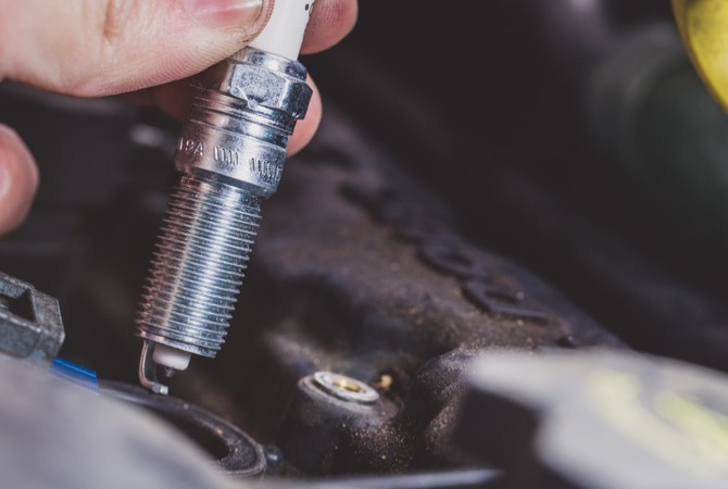 Hand holding a spark plug